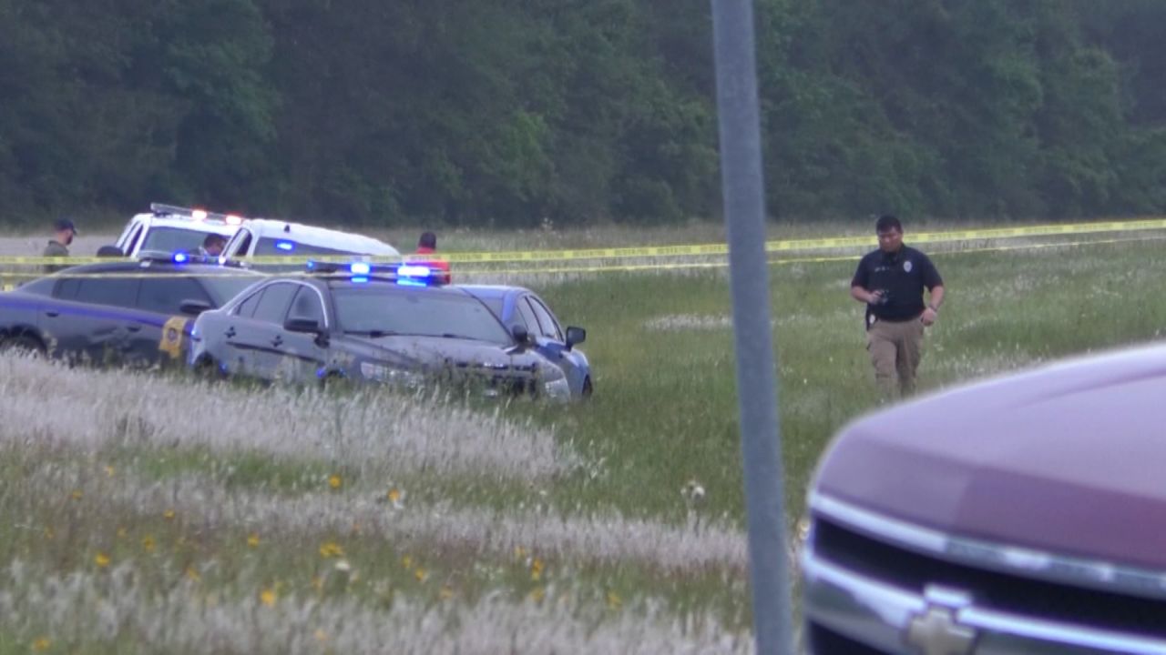 Police vehicles surround the car driven by Eric Derell Smith on May 3.