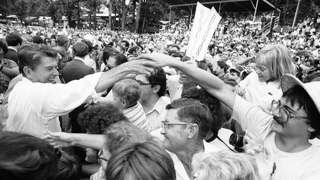 Republican presidential candidate Ronald Reagan moves through a crowd shaking hands at the Neshoba County Fair in Philadelphia, Mississippi on Sunday, August 3, 1980. The "Welfare Queen" story was part of Reagan's campaign speeches four years earlier.