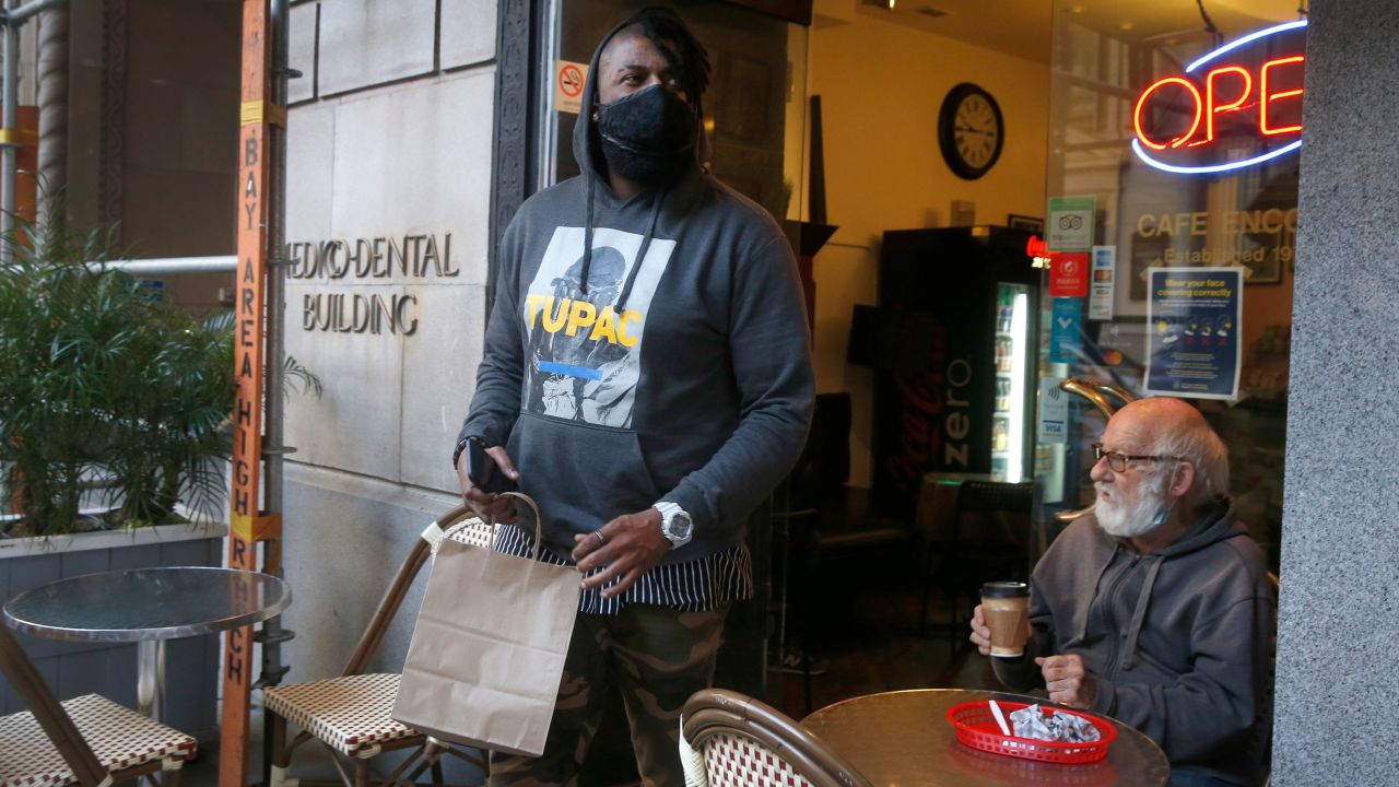 DoorDash driver Gleyson Coelho picks up an order for delivery in San Francisco on November 4, 2020. Many frontline workers have been hailed as heroes during the pandemic.