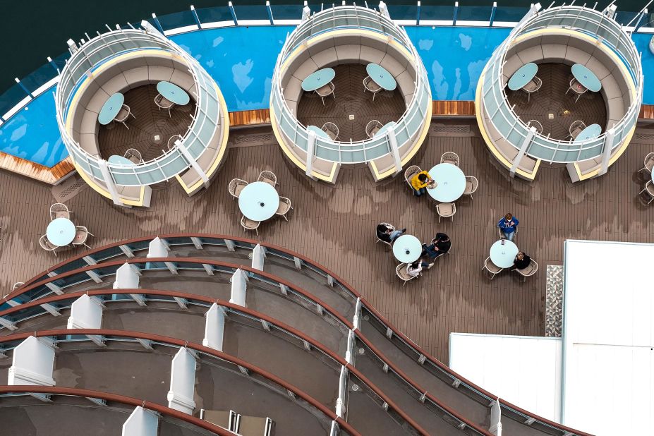 Passengers sit on the deck of the Costa Smeralda cruise ship in Savona, Italy, on May 1. The Italian cruise line Costa Cruises set sail for the first time in more than four months.