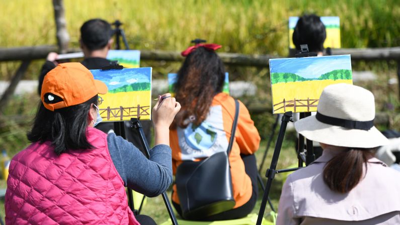 <strong>Back to their roots: </strong>Experts said China's increasingly urbanized citizens are tired of complicated entertainments and are looking for something more wholesome. These tourists are painting from nature at Xiaolingnan in eastern Anhui province.