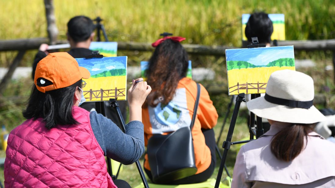 <strong>Back to their roots: </strong>Experts said China's increasingly urbanized citizens are tired of complicated entertainments and are looking for something more wholesome. These tourists are painting from nature at Xiaolingnan in eastern Anhui province.