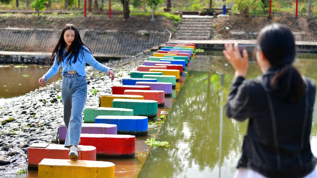 <strong>Poverty alleviation: </strong>Rural tourism isn't just popular--it is part of the Chinese government's plans to lift every citizen in the country of absolute poverty. This tourist is posing at a recently renovated dam in southern China's Guangdong province.