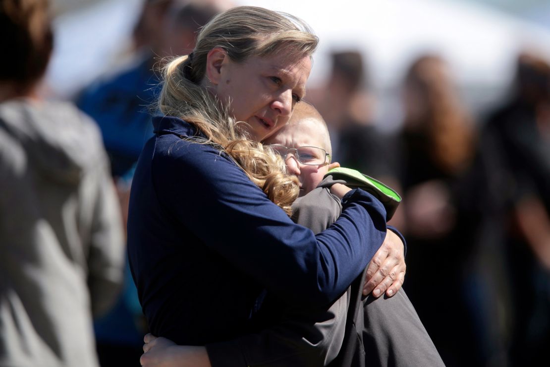 People embrace after a school shooting at Rigby Middle School in Rigby, Idaho, Thursday, May 6, 2021.