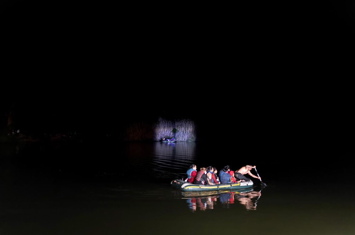 A smuggler paddles migrants across the Rio Grande while crossing the US-Mexico border in Roma, Texas, on Friday, April 30. <a href="http://www.cnn.com/2021/03/16/us/gallery/us-border-immigration-crisis/index.html" target="_blank">Related photos: This is what we're seeing at the border</a>