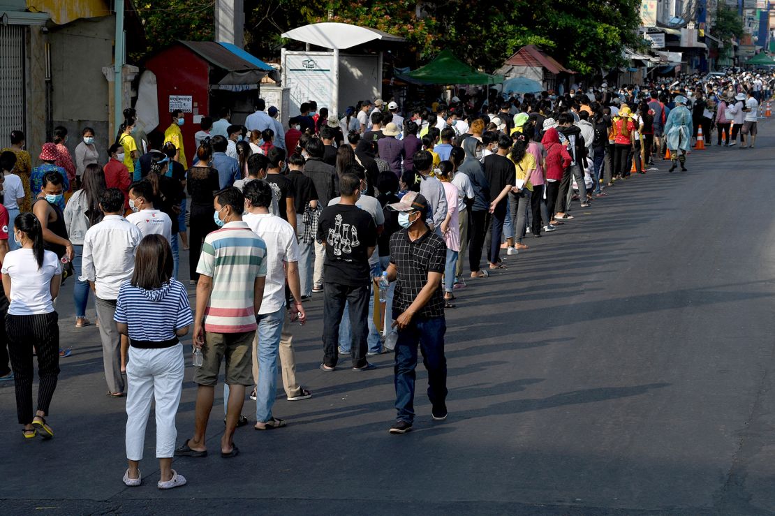 People line up to receive a dose of China's Sinopharm Covid-19 coronavirus vaccine at a school in Phnom Penh on May 3.