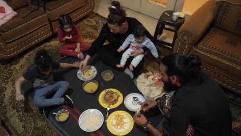 Khadija and her family gather for the nightly Iftar, composed nearly entirely of her neighbor's leftovers.
