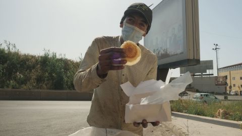 Ahmad finds a box of relatively clean atayef -- Middle Eastern pancakes -- from beneath a mound of garbage. He plans to serve it to his family during Iftar. 