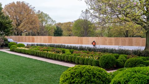 Wooden boards block the view of the South Lawn from the Rose Garden at the White House, Friday, April 9, 2021, in Washington.