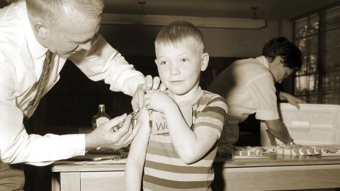 A doctor gives a measles vaccination to a boy in 1962 at Fernbank School in Atlanta. 