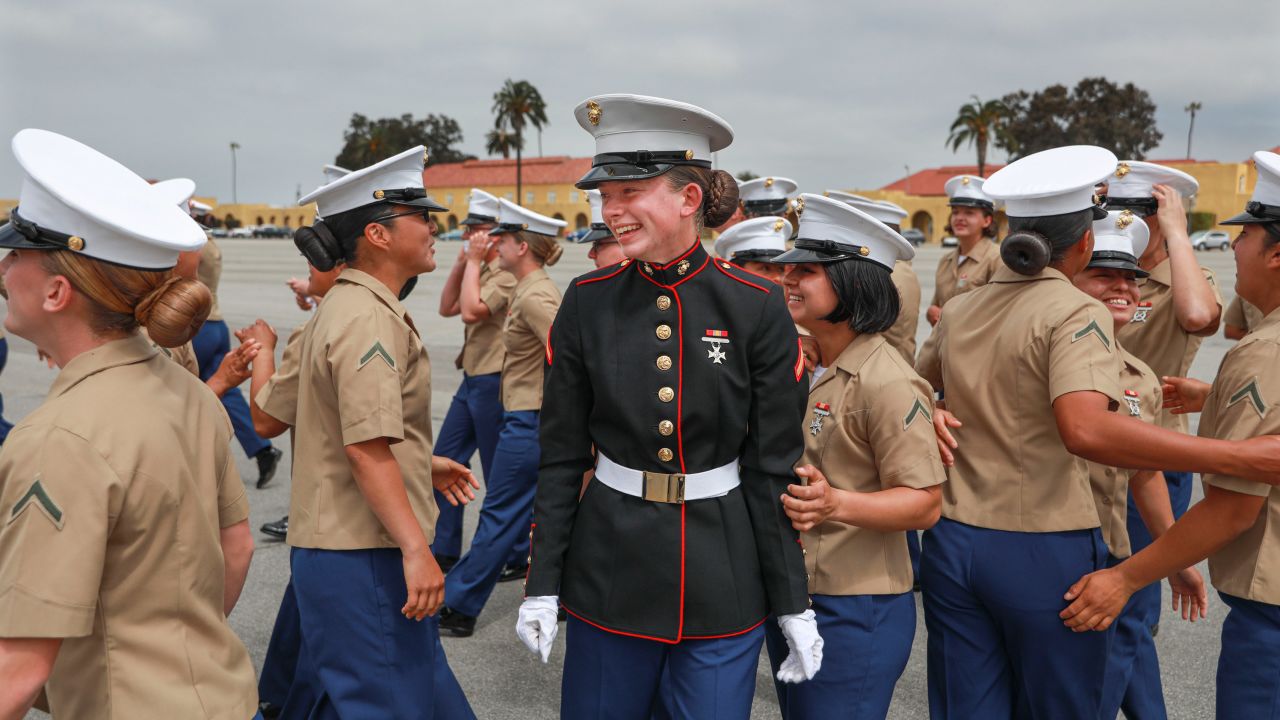 Katey Hogan (center) and members of Platoon 3241 celebrate their graduation from boot camp at the Marine Corps Recruit Depot on Thursday. They were part of the first company to train women and men recruits together. 