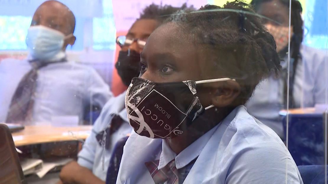 Nevaeh Bailey, learning behind a plexiglass shield in her classroom, was happy to get back to school last fall.