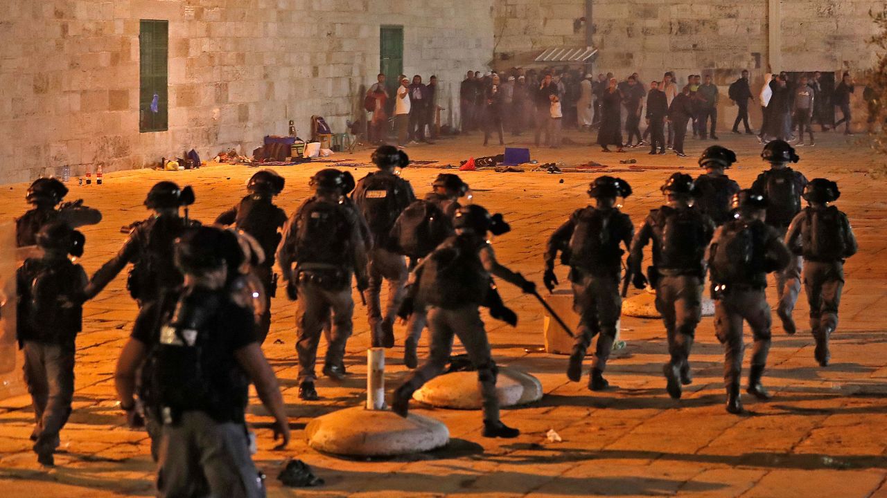 Palestinian protesters hurl rocks at Israeli security forces at Al Aqsa mosque on Friday.