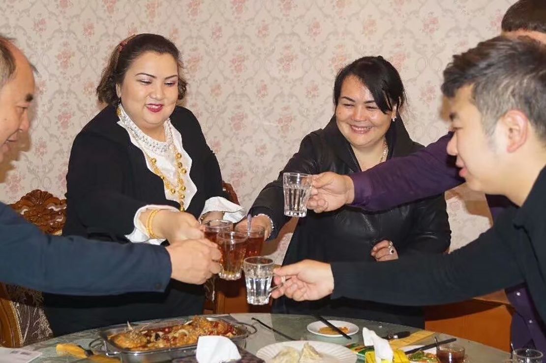 Uyghur Zumrat Dawut, second from left, says she hosted four cadres during each 10-day visit -- she and her four children were assigned one person each. 