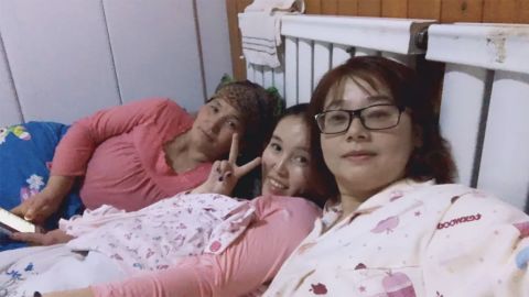 A photo posted online in 2017 shows two women in bed with a female host.