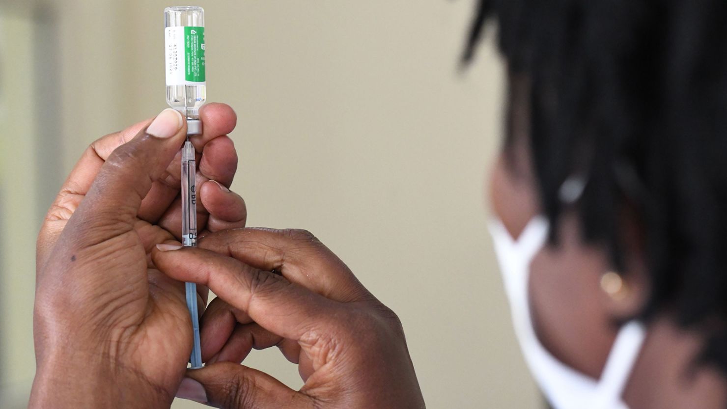 A Kenyan health worker prepares to administer a dose of the Oxford/AstraZeneca vaccine to her colleagues.