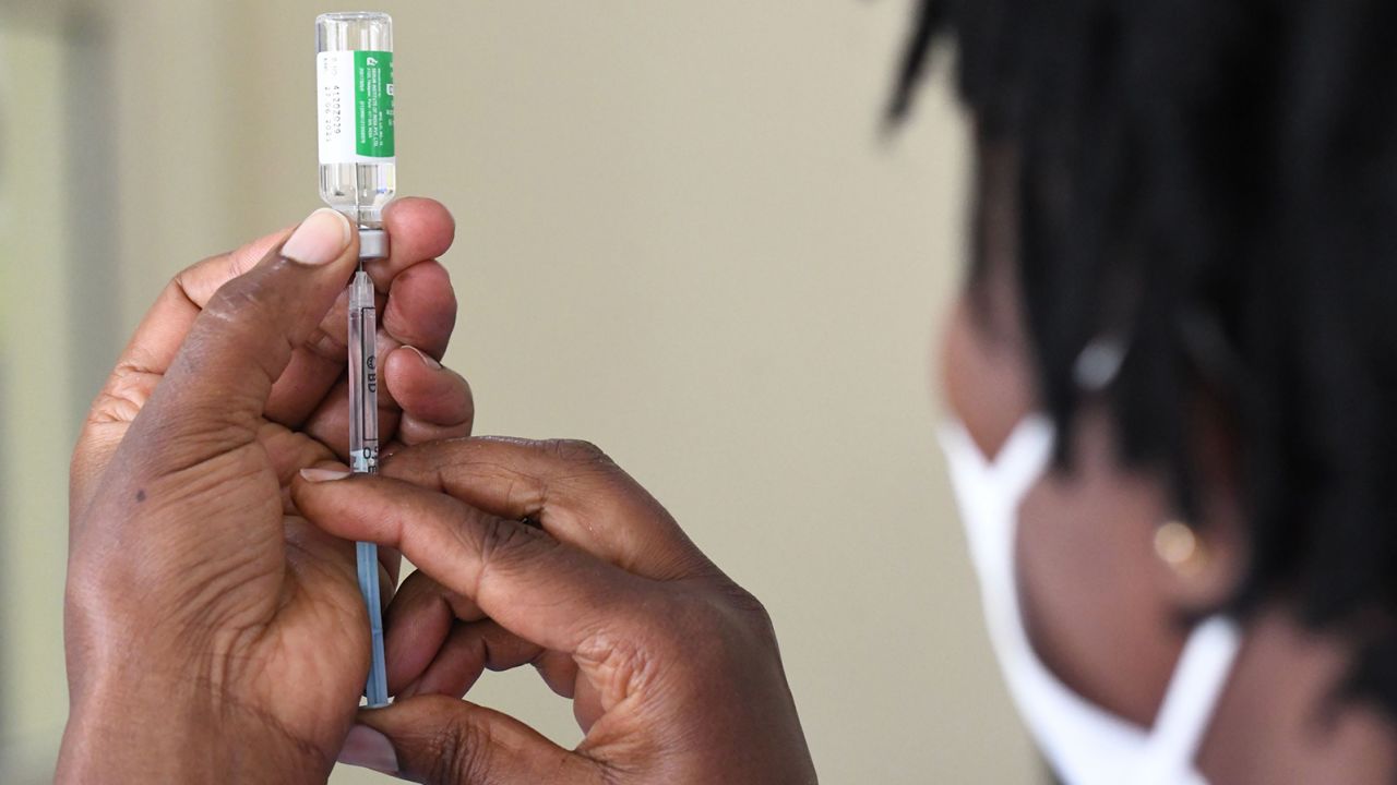 A Kenyan health worker prepares to administer the AstraZeneca vaccine to a colleague at Kenyatta National Hospital in Nairobi on March 5, 2021. Kenya has used up more than 90% of its stock of the vaccine, supplied by COVAX.