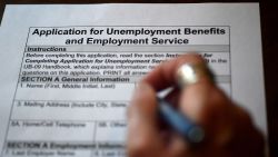 In this photo illustration, a person files an application for unemployment benefits on April 16, 2020, in Arlington, Virginia. - The government reported Thursday that another 5.2 million US workers filed for unemployment benefits, taking the four-week total to 22 million, a staggering figure in a downturn that economists say presents the country with its most severe outlook since the Great Depression of the 1930s. (Photo by Olivier DOULIERY / AFP) (Photo by OLIVIER DOULIERY/AFP via Getty Images)