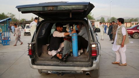 An injured man is being brought in a car to a hospital following the blast.