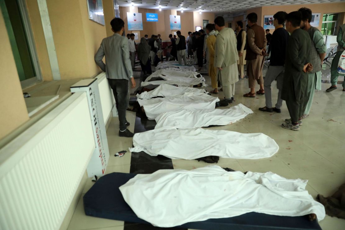 Afghan men try to identify the dead bodies at a hospital after the explosion.