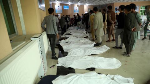 Afghan men try to identify the dead bodies at a hospital after the explosion.