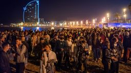 People crowded on the beach in Barcelona after the end of a six-month-long national state of emergency and the local curfew.