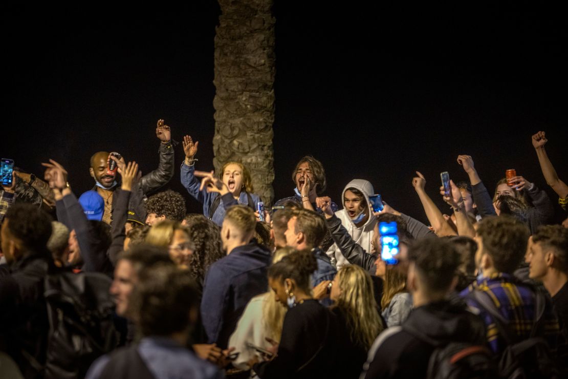 People dance on the beach in Barcelona. Spain is relaxing overall measures to contain the coronavirus this weekend, allowing residents to travel across regions.