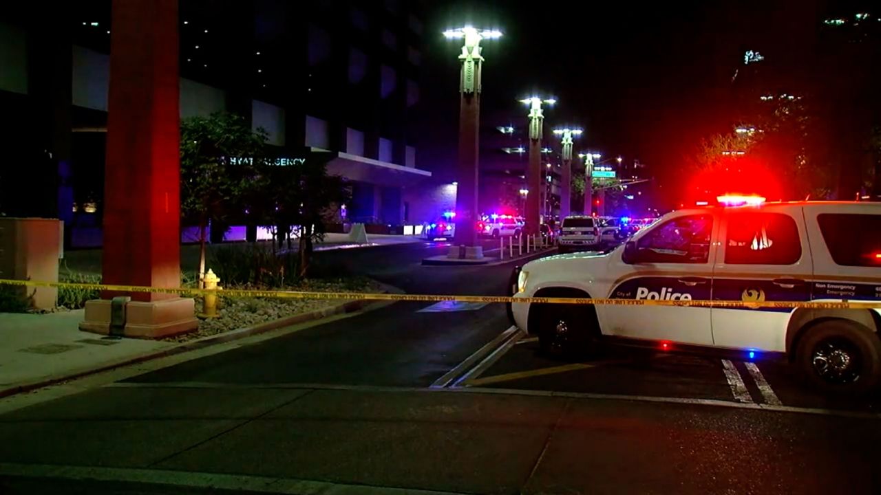 Police vehicles attend the scene of a fatal shooting in downtown Phoenix.