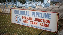 Signage is displayed on a fence at the Colonial Pipeline Co. Pelham junction and tank farm in Pelham, Alabama, U.S., on Monday, Sept. 19, 2016. Customers buying gasoline at grocery stores and other independent retailers may pay more than those shopping at name-brand outlets after the biggest gasoline pipeline in the U.S. sprung a leak in Alabama on Sept. 9. Colonial Pipeline Co. has proposed restarting the line on Sept. 22, according to the Alabama Emergency Management Agency. Photographer: Luke Sharrett/Bloomberg via Getty Images