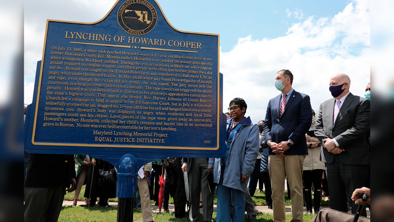 Maryland Gov. Larry Hogan, far right, Baltimore County Executive John Olszewski and Maryland House Speaker Adrienne Jones stand next to a new historic marker on Saturday in Towson, Maryland, that memorializes Howard Cooper, a 15-year-old who was dragged from a jailhouse and hanged from a tree by a mob of white men in 1885. Hogan signed a posthumous pardon for 34 men, including Cooper, who were lynched in the state between 1854 and 1933 without due process against allegations they faced.