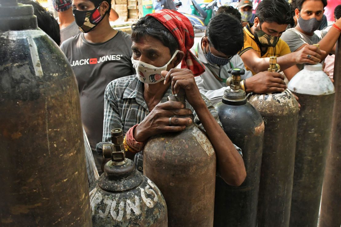 Indians wait to refill oxygen cylinders for Covid-19 patients at a gas supplier facility in New Delhi on May 8.