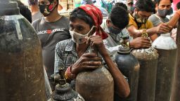 Indians wait to refill oxygen cylinders for COVID-19 patients at a gas supplier facility in New Delhi, India, Saturday, May 8, 2021. Infections have swelled in India since February in a disastrous turn blamed on more contagious variants as well as government decisions to allow massive crowds to gather for religious festivals and political rallies. (AP Photo/Ishant Chauhan)
