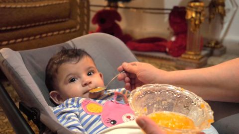 Khadija feeds her 5-month old daughter, Lamees. 