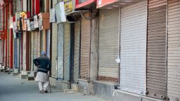 SRINAGAR, INDIA - 2021/05/09: An elderly man walk past closed shops during a coronavirus curfew imposed by the authorities following the surge in COVID-19 cases in Srinagar.
Coronavirus curfew in Jammu and Kashmir has been extended till May 17 to contain the surge in coronavirus cases, officials said on Sunday. Meanwhile, India recorded 403,738 new COVID-19 cases and 4,092 deaths in the last 24 hours. (Photo by Saqib Majeed/SOPA Images/LightRocket via Getty Images)