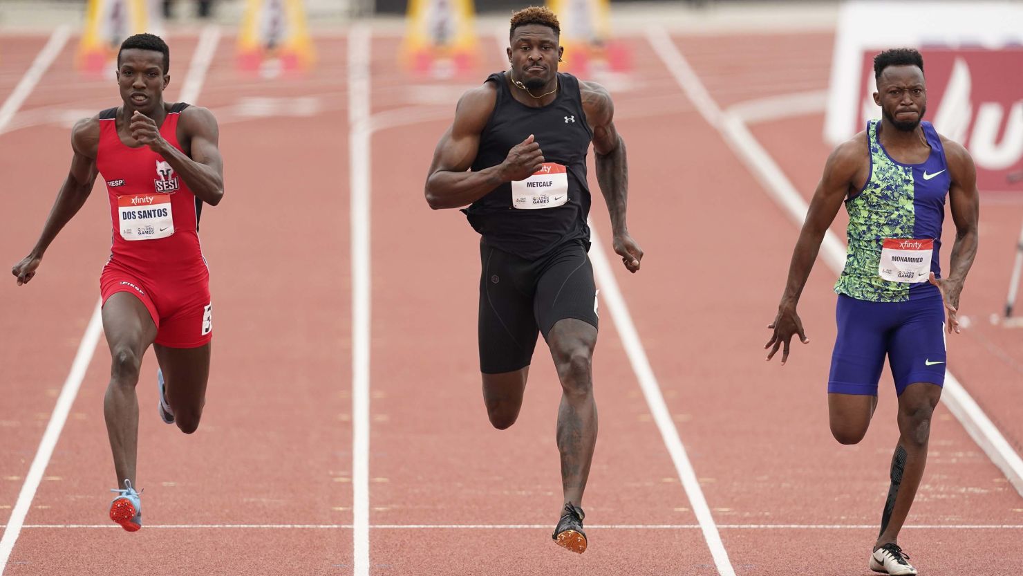 Seattle Seahawks wide receiver DK Metcalf competes in the second heat of the men's 100-meter race.