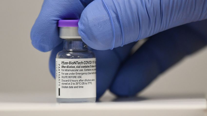 CARDIFF, WALES - DECEMBER 08: A member of staff poses with a phial of Pfizer-BioNTech Covid-19 vaccine at a vaccination health centre on the first day of the largest immunisation programme in the UK's history on December 8, 2020 in Cardiff, United Kingdom. Wales joined the other UK nations in rolling out the covid-19 vaccine on Tuesday, a rare moment of coordination after months of disjointedness in the four nations' pandemic response. Wales introduced a 17-day "firebreak" lockdown in October and November to suppress the surge in covid-19 cases, but infections have continued to rise. (Photo by Justin Tallis/Pool/Getty Images)