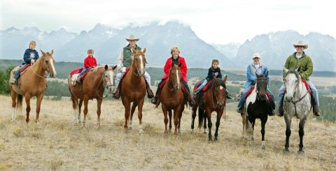 Liz Cheney, second from right, rides horses with her parents, her children and her husband in Moose, Wyoming, in August 2004. With her, from left, are her daughter Kate, her daughter Grace, her parents, her daughter  Elizabeth and her husband, Phillip Perry. Cheney married Perry, a lawyer, in 1993. They have five children in all.