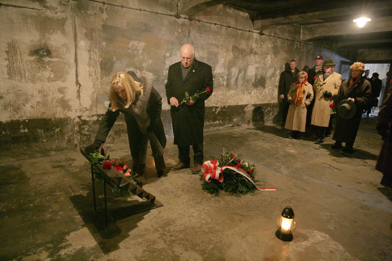 Cheney and her father lay flowers at an Auschwitz memorial near Krakow, Poland, in 2005.