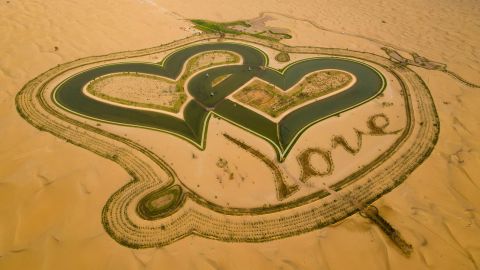 TOPSHOT - A picture taken with a drone on July 31, 2019, shows the new man-made "Love lake" at al-Qudra desert in the Gulf emirate of Dubai. (Photo by GIUSEPPE CACACE / AFP) (Photo by GIUSEPPE CACACE/AFP via Getty Images)