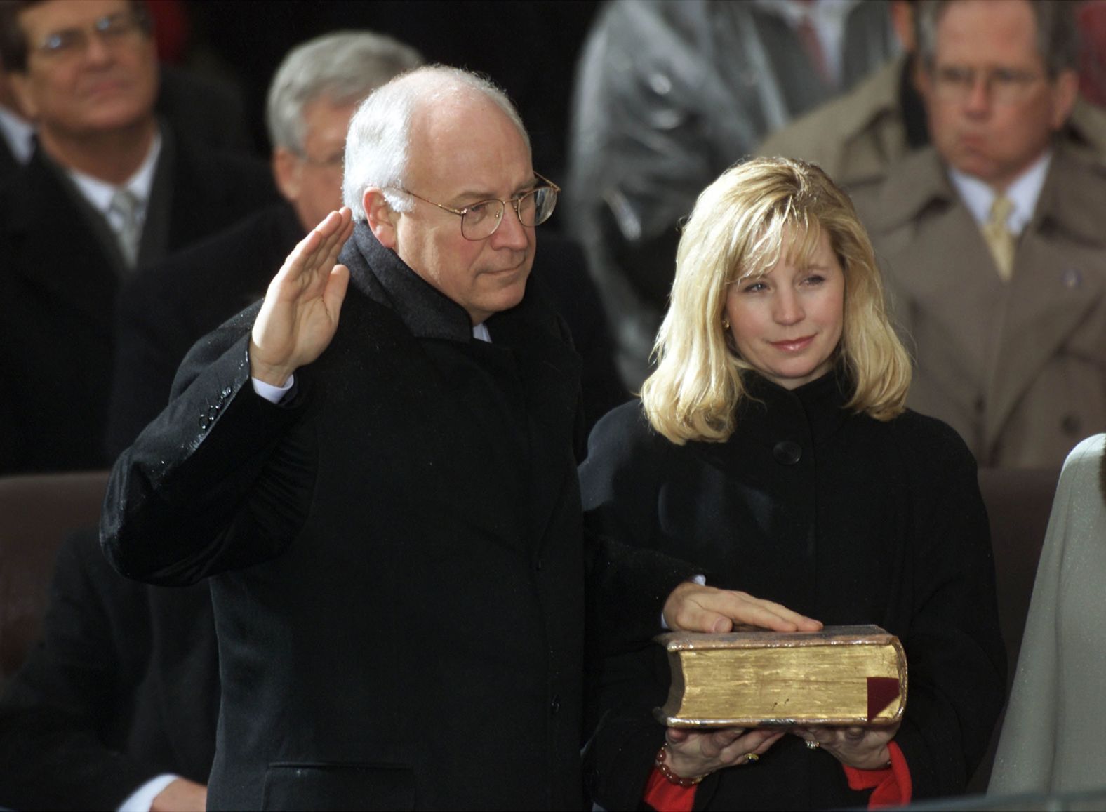 Liz Cheney holds the Bible for her father as he's sworn in as vice president in 2001.