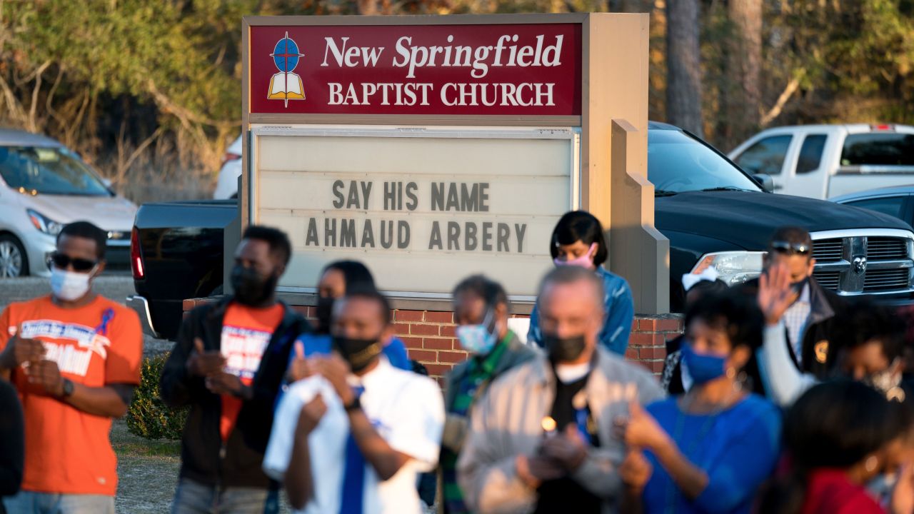People participate in a candlelight vigil for Ahmaud Arbery in Waynesboro, Georgia, on the anniversary of his death, February 23, 2021.