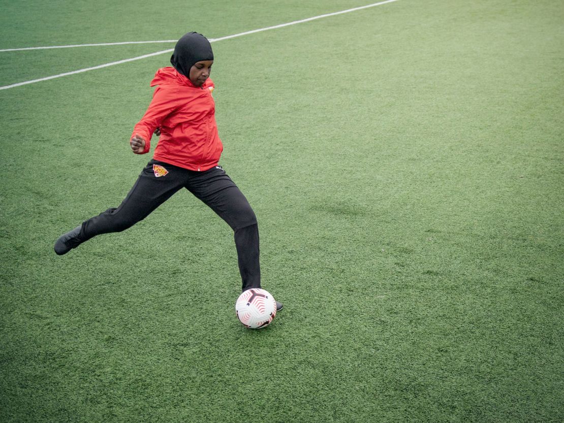 A player passes a ball while wearing a Nike Pro hijab.