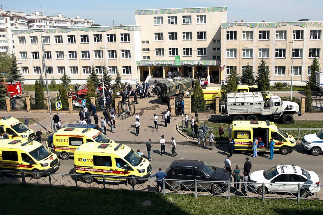 Ambulances and police cars are parked at a school after a shooting in Kazan, Russia.
