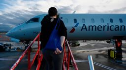Passengers board an American Airlines flight at Ronald Reagan Washington National Airport in Arlington, Virginia on April 11, 2021.