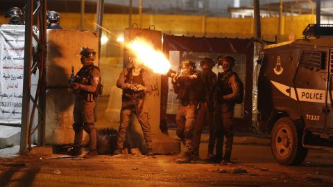 IDF soldiers fire tear gas at Palestinian demonstrators at the Qalandiya checkpoint between Ramallah and Jerusalem, in the West Bank on Tuesday.