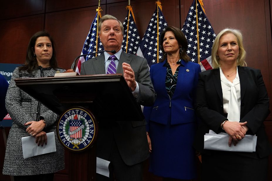 Stefanik, left, stands behind US Sen. Lindsey Graham during a Capitol Hill news conference in December 2017. Lawmakers unveiled bipartisan legislation to help prevent sexual harassment.