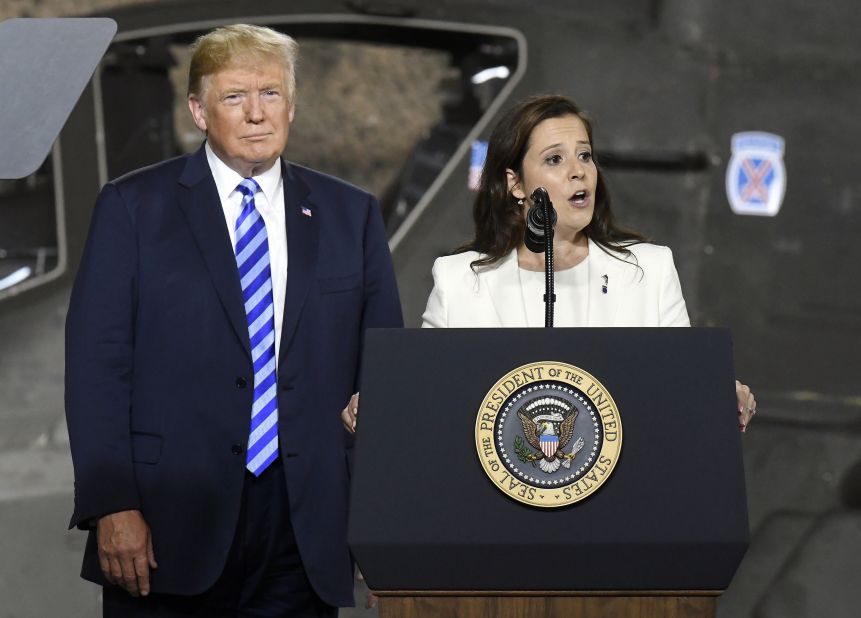 President Donald Trump listens to Stefanik at Fort Drum, New York, before signing a $716 billion defense bill in August 2018.