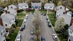 Vehicles parked outside residential homes in Manhasset, New York, on Friday, April 16. 