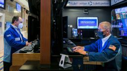 In this photo provided by the New York Stock Exchange, trader Timothy Nick, right, works in his booth on the floor, Monday May 3, 2021. 