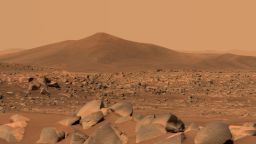 NASA's Perseverance Mars rover used its dual-camera Mastcam-Z imager to capture this image of "Santa Cruz," a hill about 1.5 miles (2.5 kilometers) away from the rover, on April 29, 2021, the 68th Martian day, or sol, of the mission. The entire scene is inside of Mars' Jezero Crater; the crater's rim can be seen on the horizon line beyond the hill.
This scene is not white balanced; instead, it is displayed in a preliminary calibrated version of a natural-color composite, approximately simulating the colors of the scene as it would appear to a person on Mars. An enhanced color version is also included.
